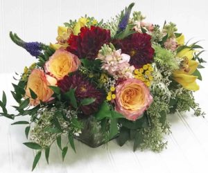 peach and yellow garden roses with ruby red dahlias and lots of greenery