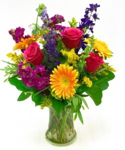 Hot pink roses coupled with vivid orange gerbera daisies are bound to brighten anyone's day.