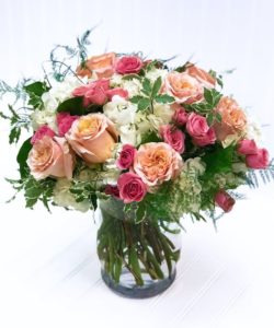 Our Juliette design screams romance with roses in peach and pink tones accented with cascading greenery. Perfect for the Juliette to your Romeo.